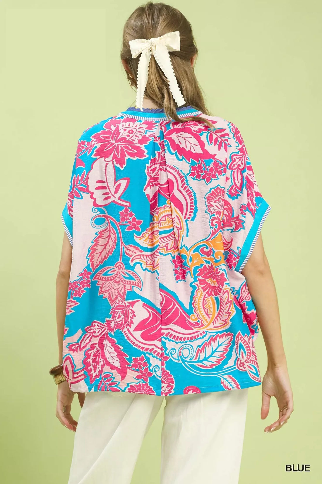 Back of oversized blue print top with pink floral paisley and short sleeves