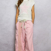 Ivory popcorn knit top with round neck and cap sleeves, pink star motif