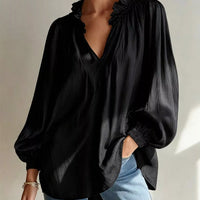Black ruffle-trim long-sleeve blouse with V-neck and gathered shoulder ruffles