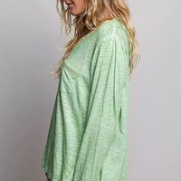 Light green V-neck knit long sleeve top with contrast-stitched neckline