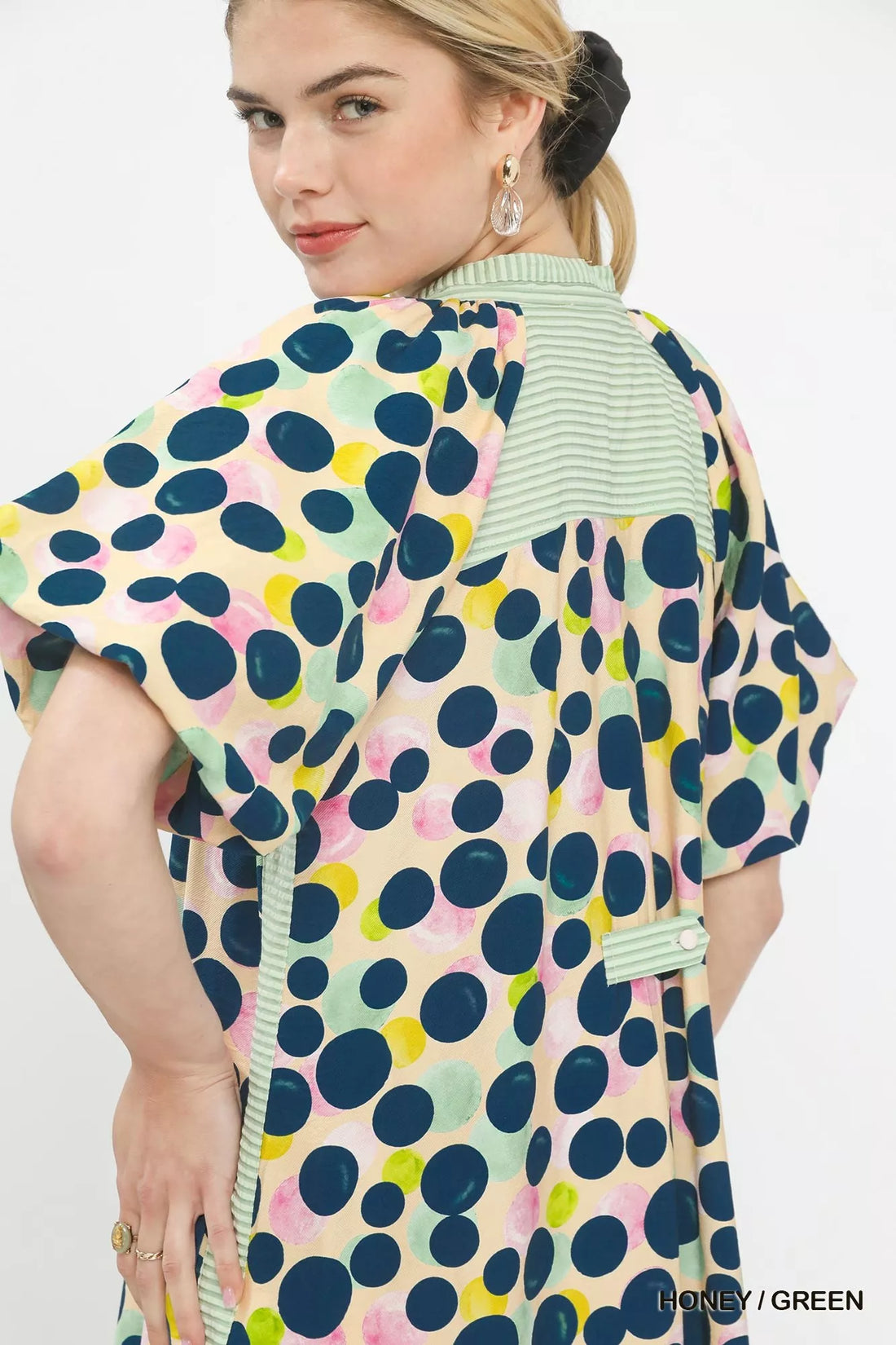 Polka dot tunic dress close-up back with ruffled trim and striped V-neck facing
