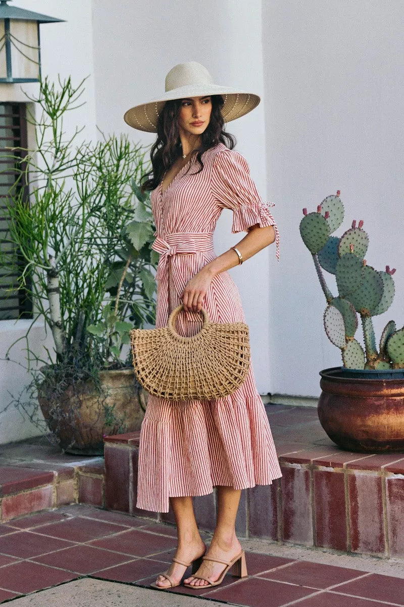 Red-and-white striped wrap midi dress with V-neck, short puff sleeves, tied waist