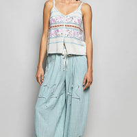 Cream and blue printed cami with button placket, tassels, and blanket-stitch trim