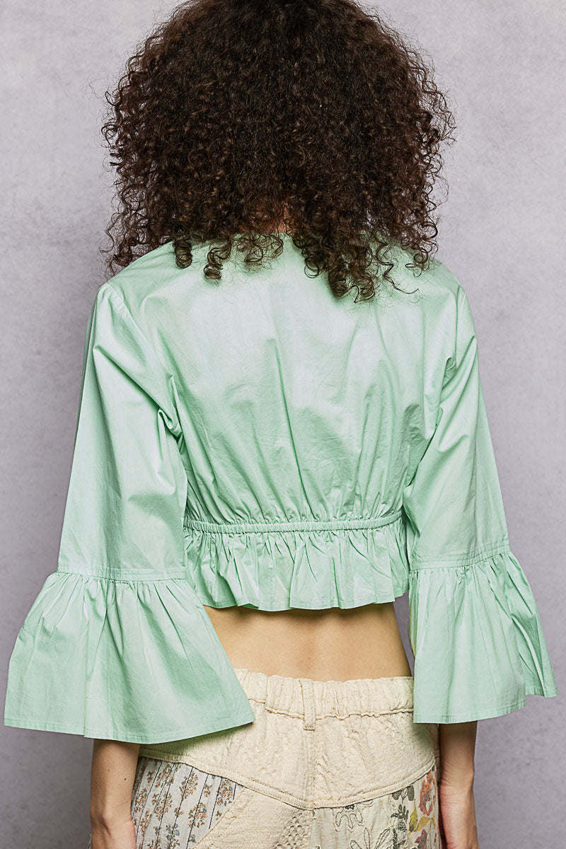 Mint floral embroidered cropped blouse back view with gathered ruffle waist