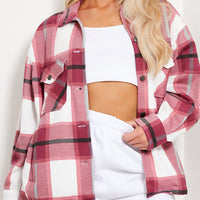 Pink plaid women’s shacket with chest pockets, button front, and long sleeves