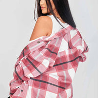 Women’s pink plaid shacket worn over shoulder with chest pocket and button front