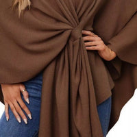 Women’s shawl cape close-up: front tie knot with gathered pleats over denim