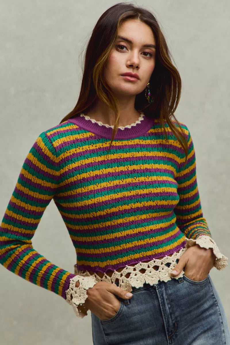 Striped cropped knit top with crochet edge hem and long sleeves in purple, green, and gold