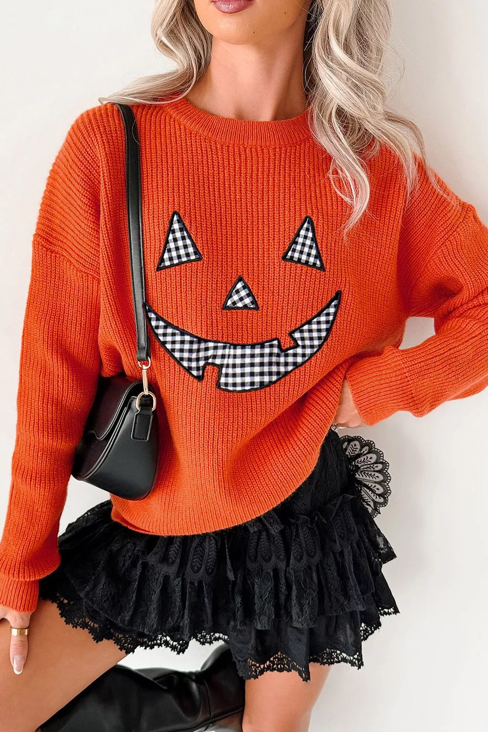 Orange Halloween sweater with jack-o-lantern face print and long sleeves