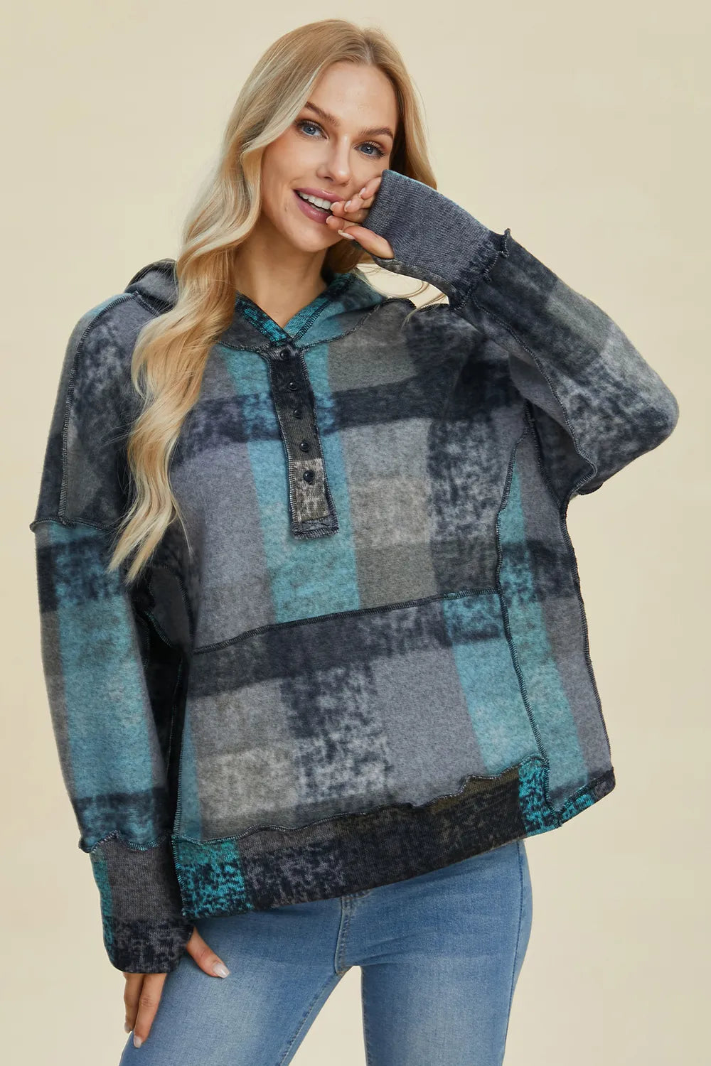Plaid fleece hoodie with hood, half-zip, dropped shoulders, front diagonal view.