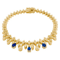Gold tennis bracelet with blue teardrop stones, gold links, and secure clasp