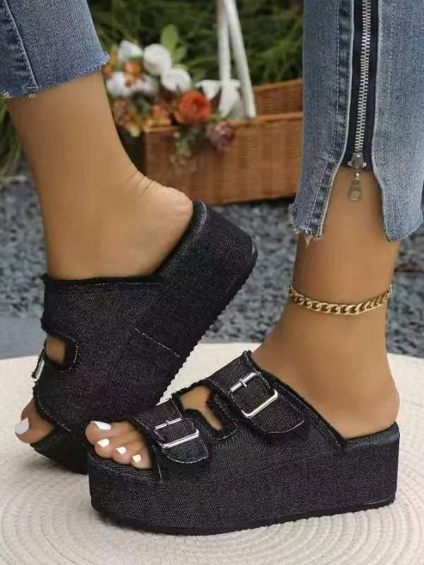 Black textured wedge sandals with two wide straps and square metal buckle details