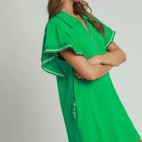 Green mini dress with half-zip front and flared butterfly sleeves with ruffle trim