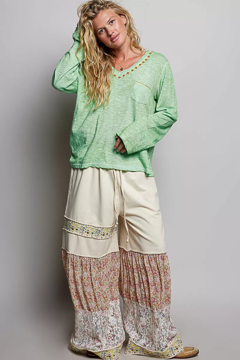 Light green V-neck knit long sleeve top with contrast trim and chest pocket