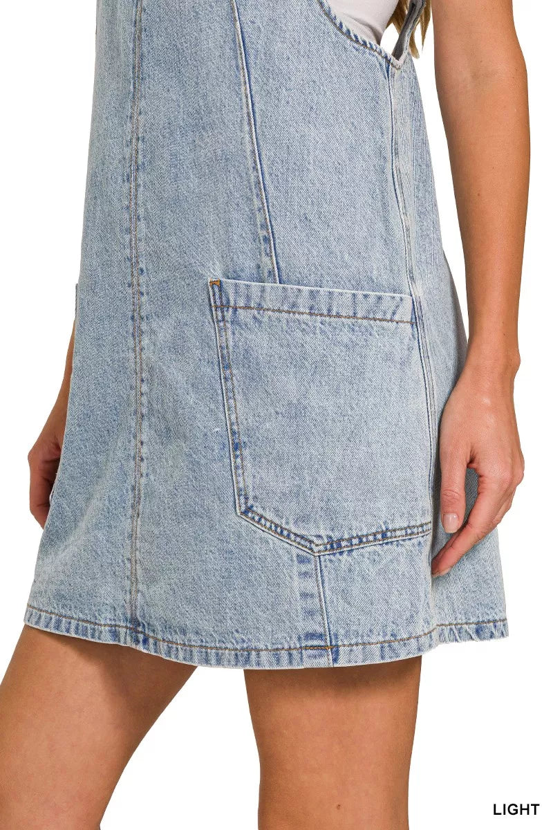 Light wash denim overall dress hem with front patch pocket and blue topstitching