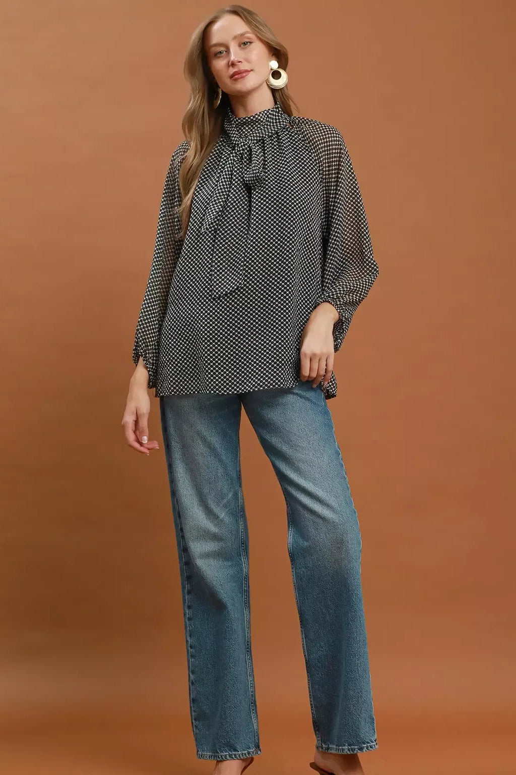 Black and white dot print tie-neck blouse with long sleeves and relaxed body