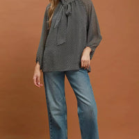 Black and white dot print tie-neck blouse with long sleeves and relaxed body