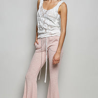 Blush pink ribbed knit drawstring pants with wide leg and flared hem