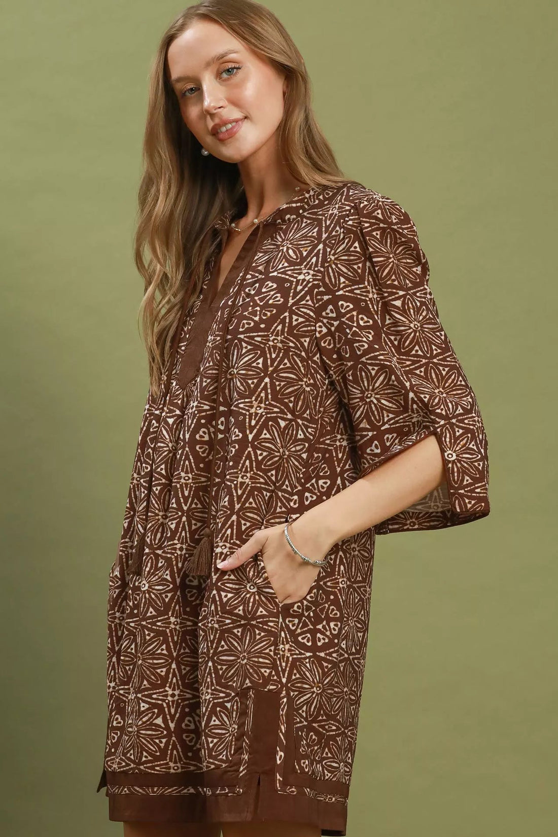 Brown geometric print tunic dress with V-neck and tassel tie, flared sleeves