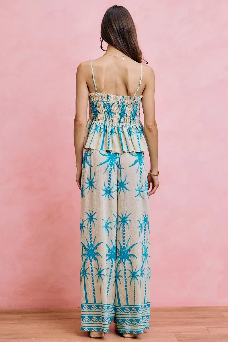 Back view of blue palm tree smocked bodice adjustable cami top with thin straps