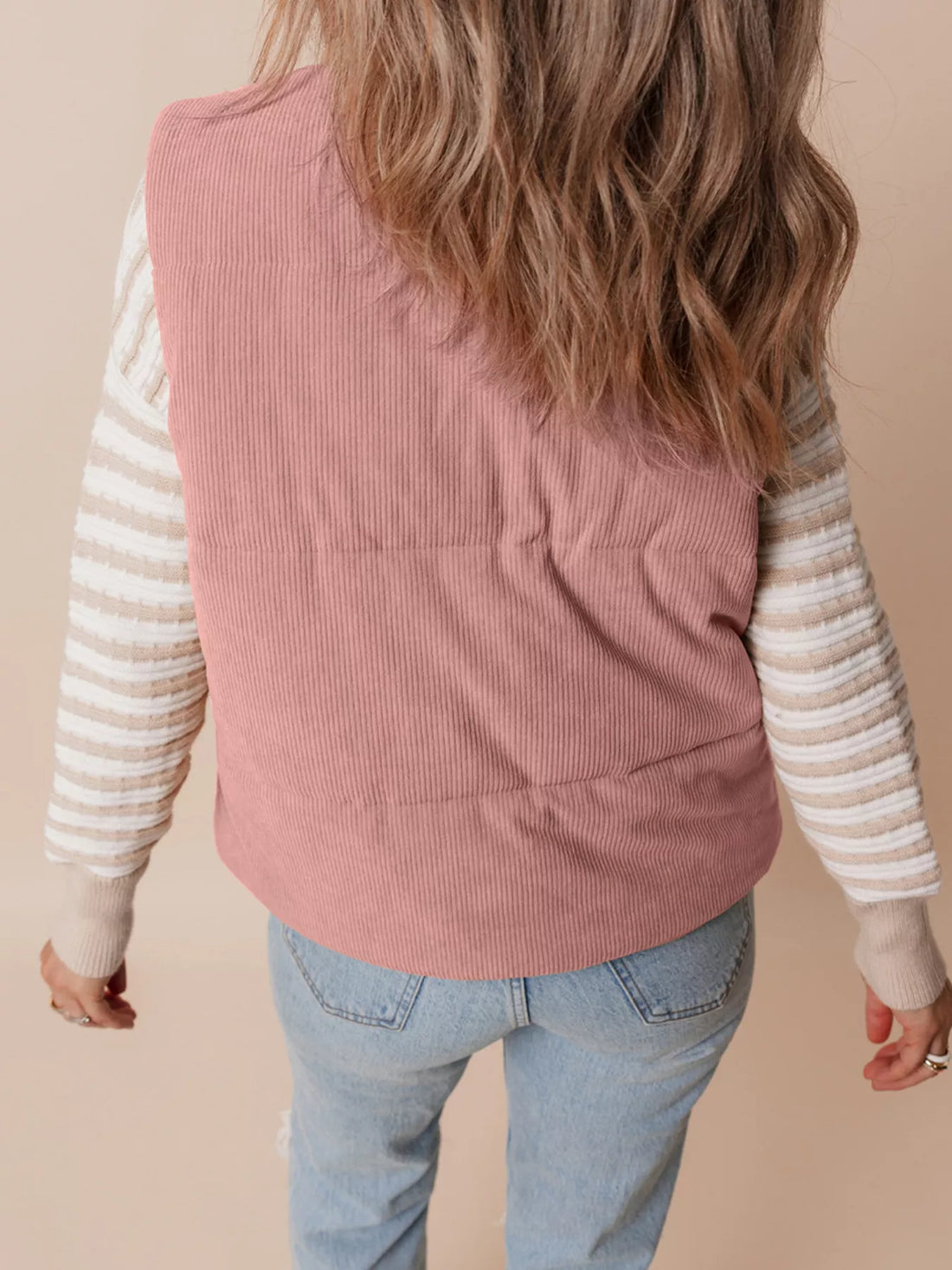 Dusty pink corduroy stand-neck zipped puffer vest, back view with quilted panels.