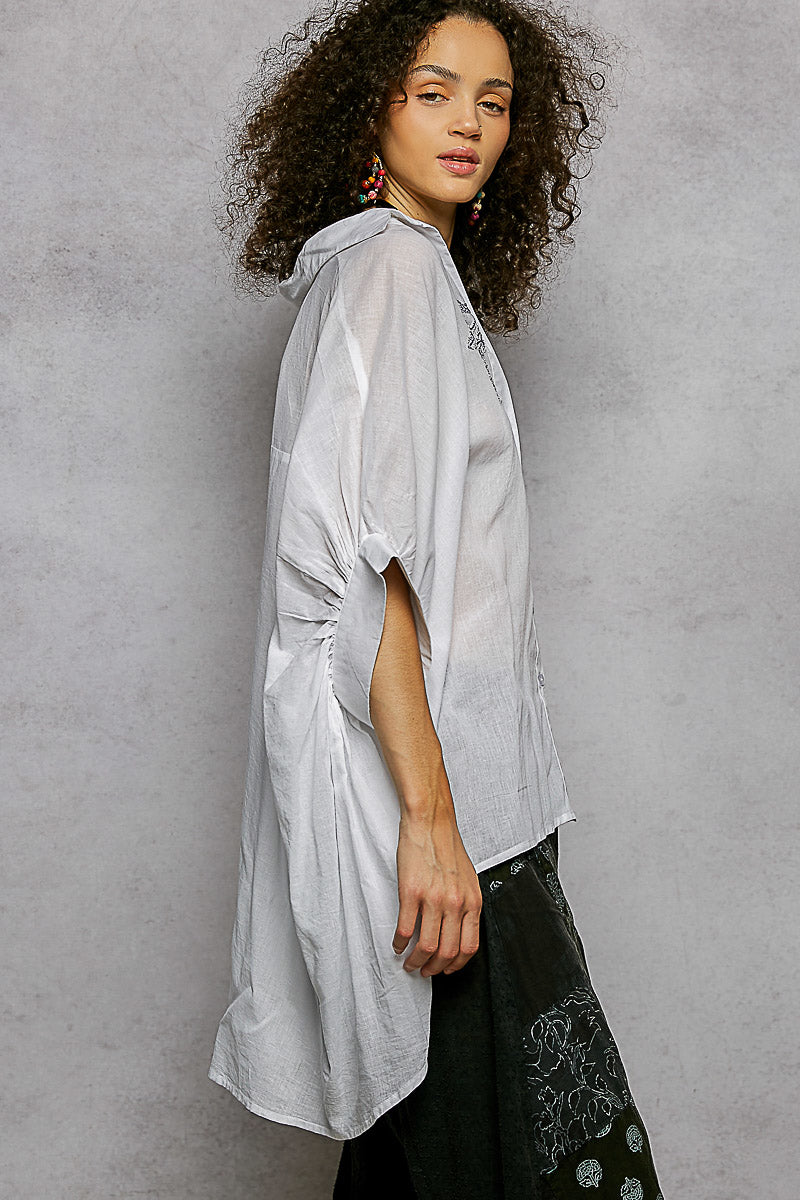 Ivory embroidered floral button-front shirt, side profile with relaxed draped sleeves