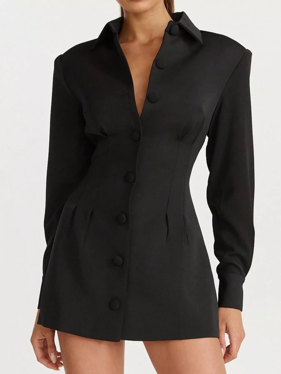 Black blazer-style mini dress with notched collar and long sleeves, featuring button details.