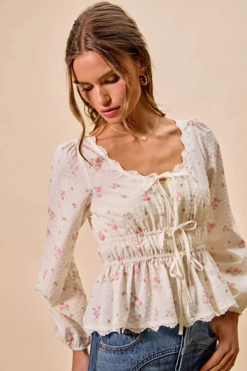 White floral clip-dot blouse with ruched elastic waist, lace-trim neckline, and long puff sleeves