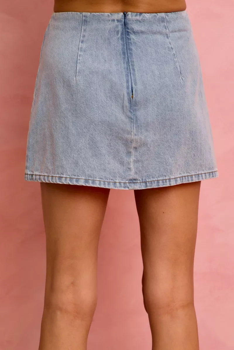 Light blue denim mini skirt with a simple front and frayed hem edge.