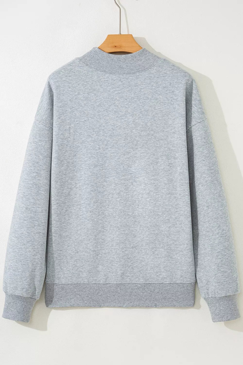 Gray long-sleeve sweatshirt back on hanger, plain design with crew neck
