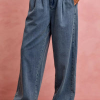 Women's denim wide-leg jeans with ruffled waist, side pockets, and relaxed fit