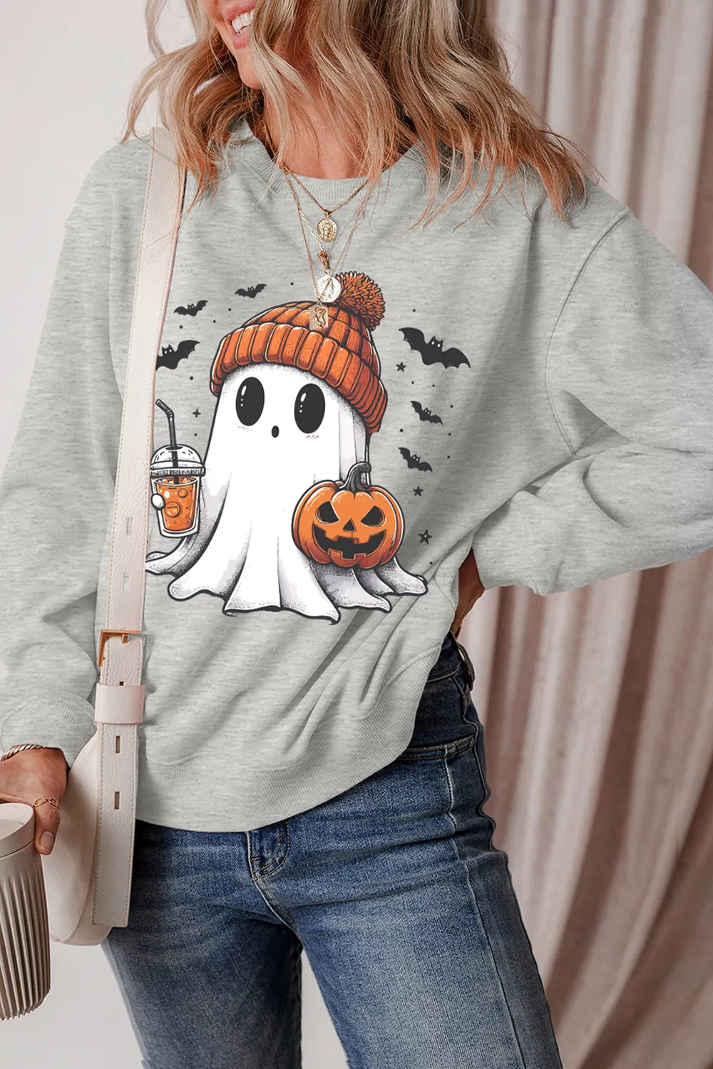 Gray crew sweatshirt with ghost holding pumpkin and striped knit beanie