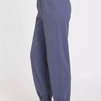 Indigo-blue scuba joggers, elastic waistband, tapered ankle cuffs, side pockets