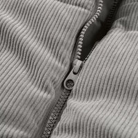 Gray corduroy puffer vest zipper close-up with visible zipper pull and stitched placket.