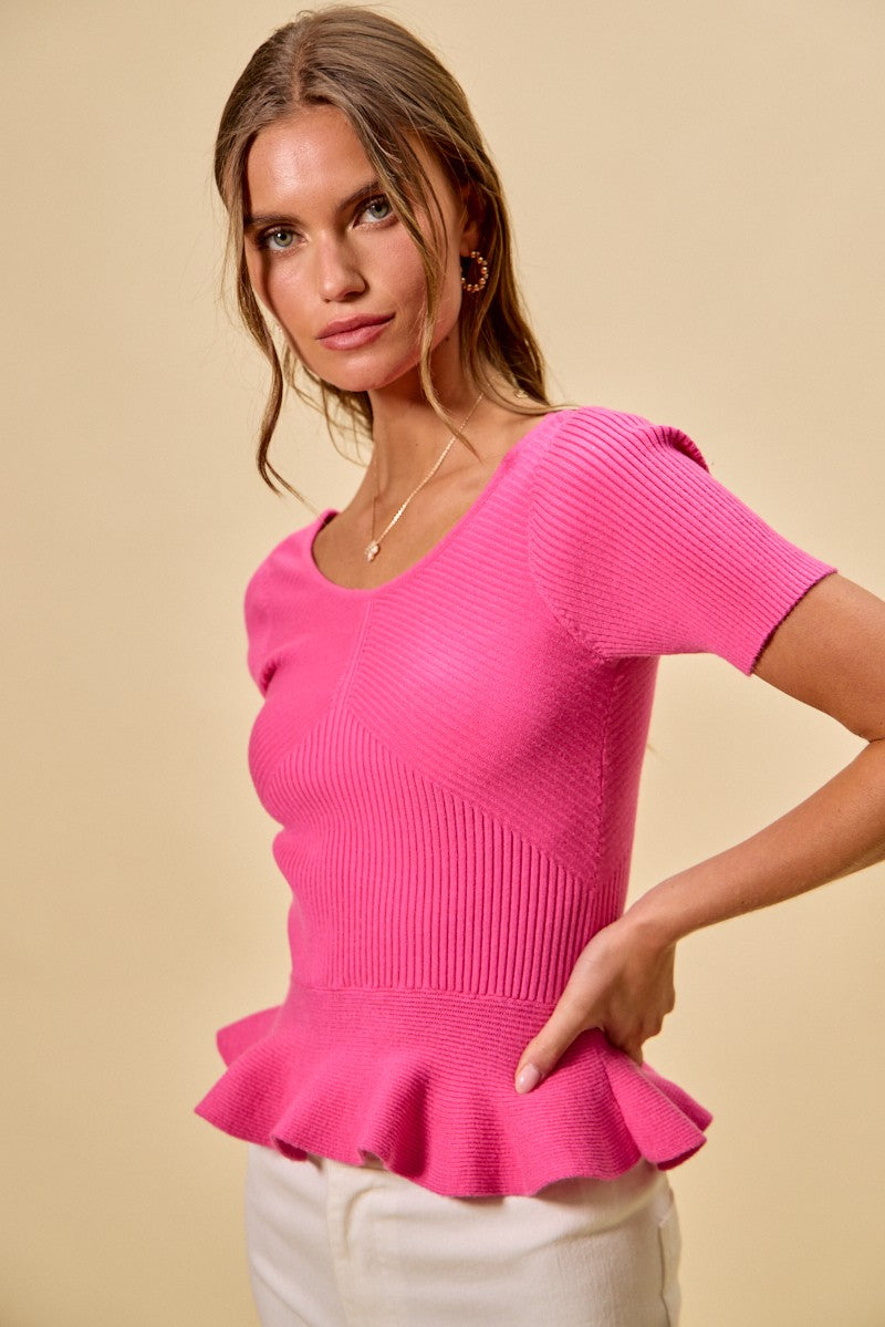 Hot pink ribbed knit peplum sweater top with ruffled peplum hem