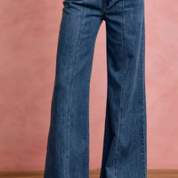 Mid-rise stretch denim jeans with wide flared legs, front center seam detail