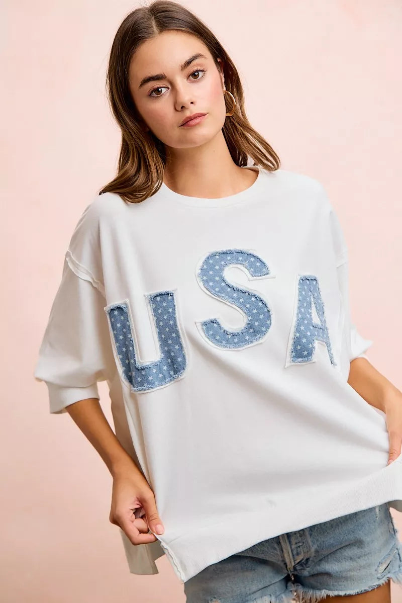 Ivory french terry pullover top with blue "USA" patch appliques and wide short sleeves