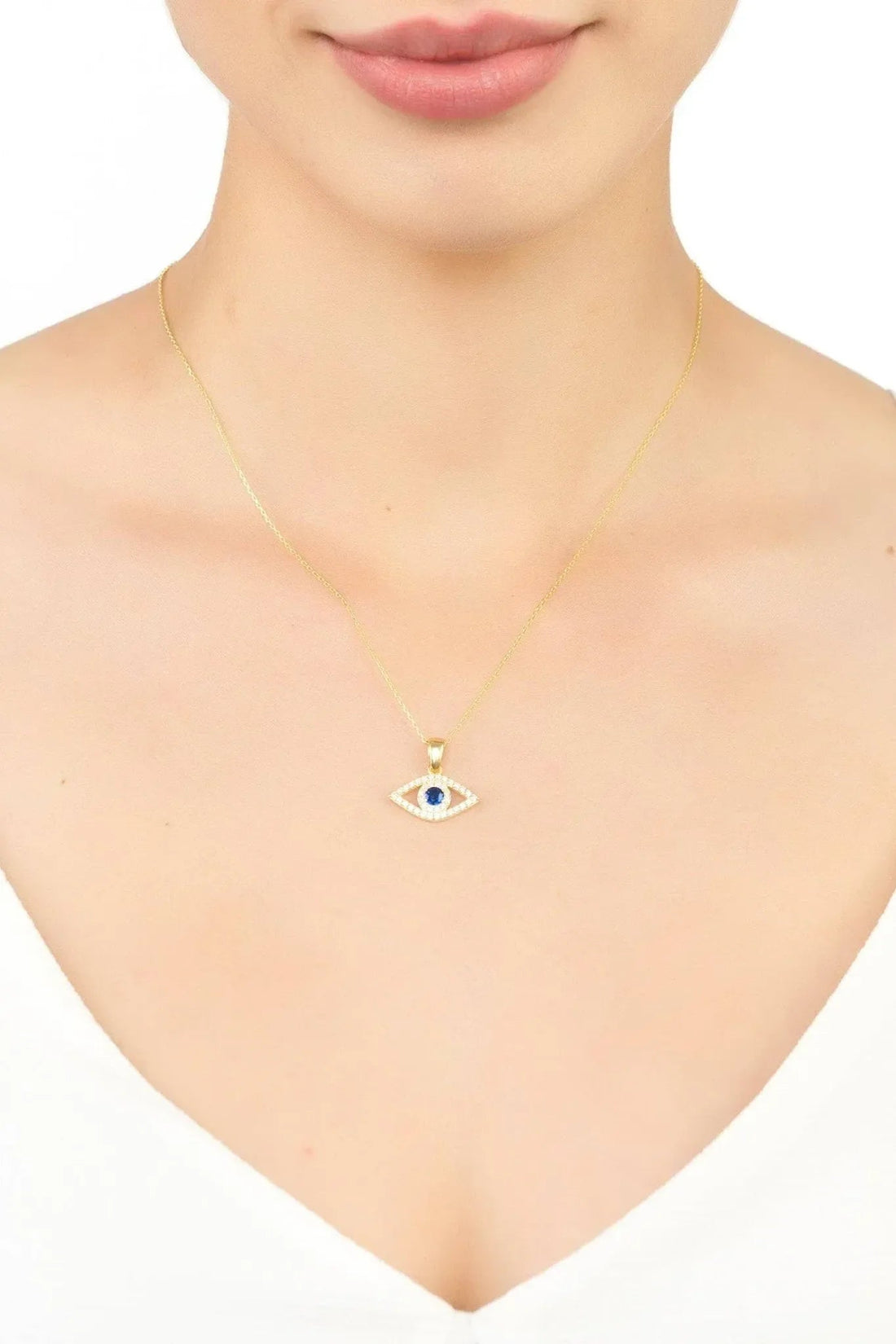 Gold-tone evil eye necklace with small blue eye pendant on a fine chain