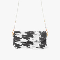 Black and white patterned shoulder bag with curved flap and gold chain strap