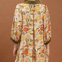 Floral shift mini dress back view with olive contrast trim and three-quarter puff sleeves