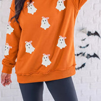 Orange mock neck sweatshirt with white ghost appliques and ribbed cuffs