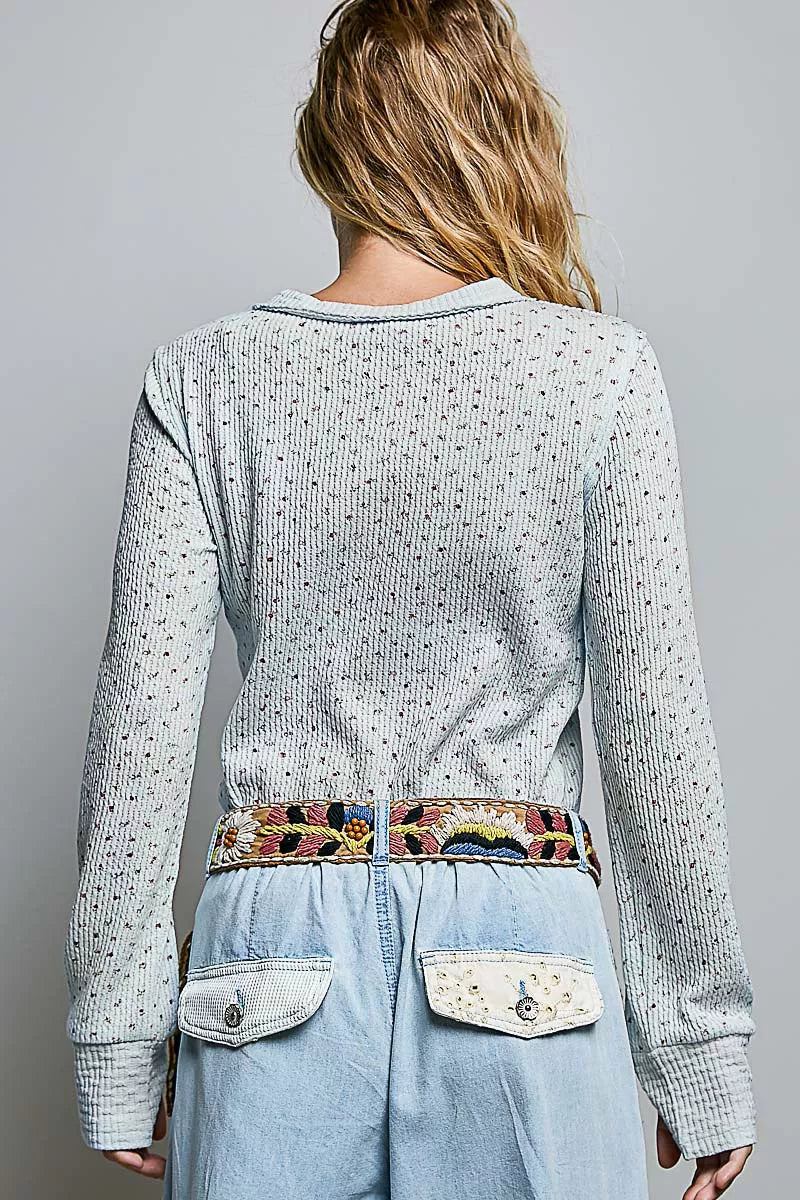 Back view of light blue speckled knit crew neck long-sleeve top