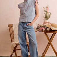Striped sleeveless vest top with ruffled shoulders and red-trim details, front view