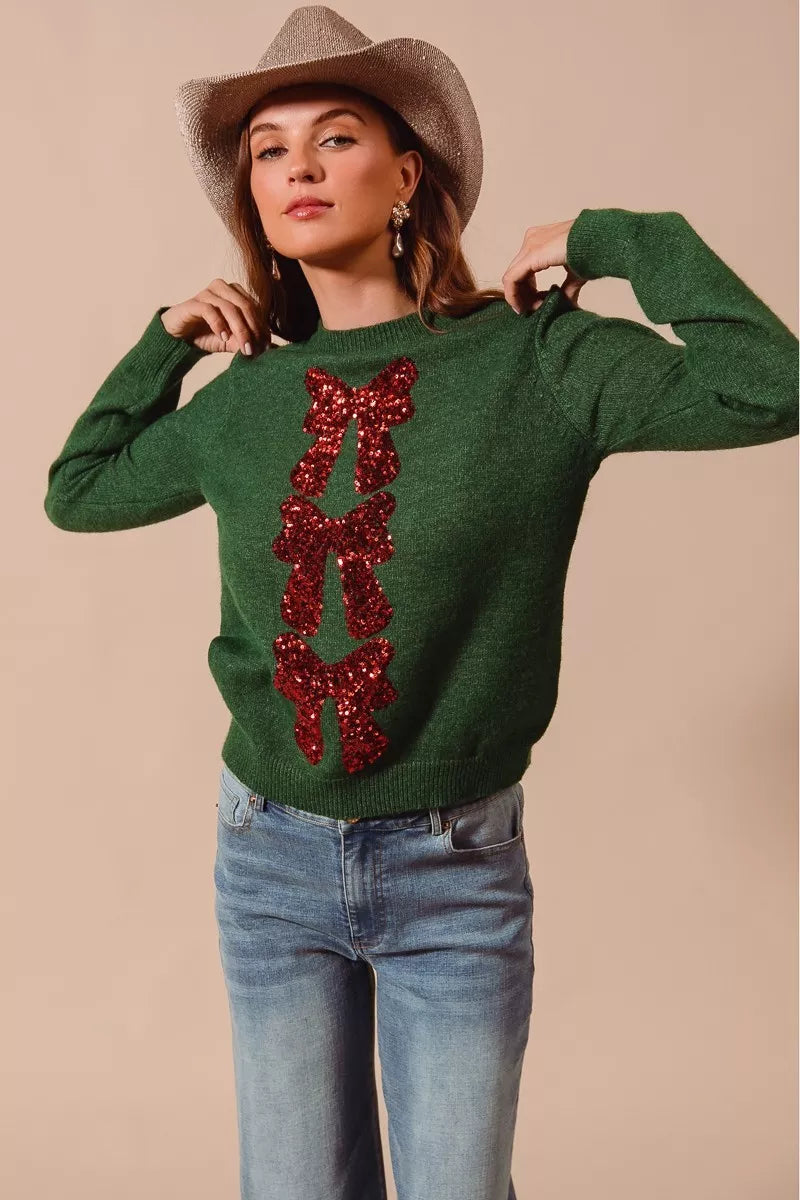 Green Christmas sweater with red sequin bow ribbon applique on front