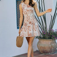 Lined mini dress with smocked bodice and coral-brown shell print, sleeveless and flared