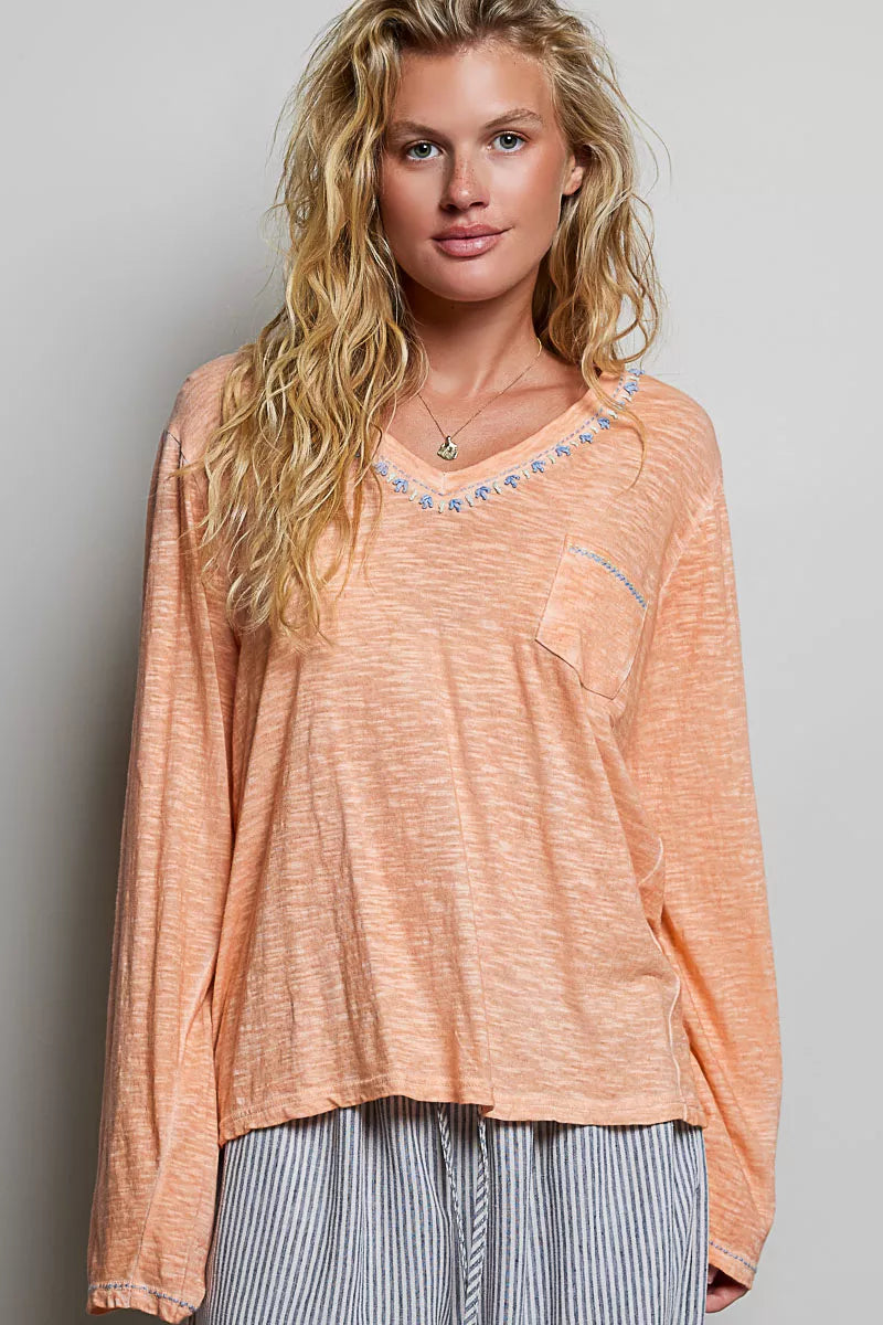 Peach V-neck lightweight knit long-sleeve top with contrast-trim neckline and pocket