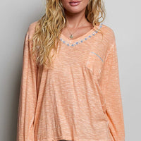 Peach V-neck lightweight knit long-sleeve top with contrast-trim neckline and pocket