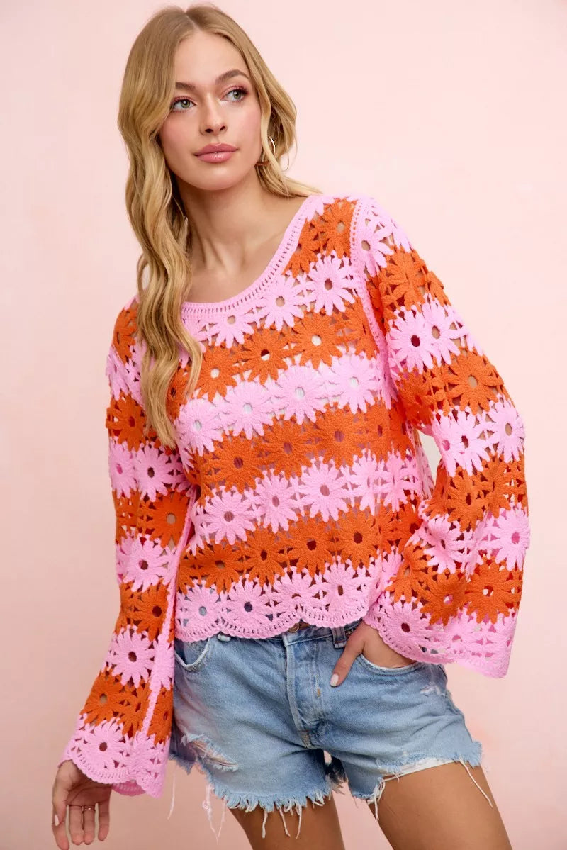 Crochet knit top with orange and pink floral pattern, long sleeves, scoop neck.