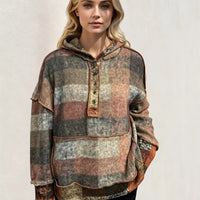 Plaid fleece hoodie with dropped shoulders, front half-zip, kangaroo pocket, front view.