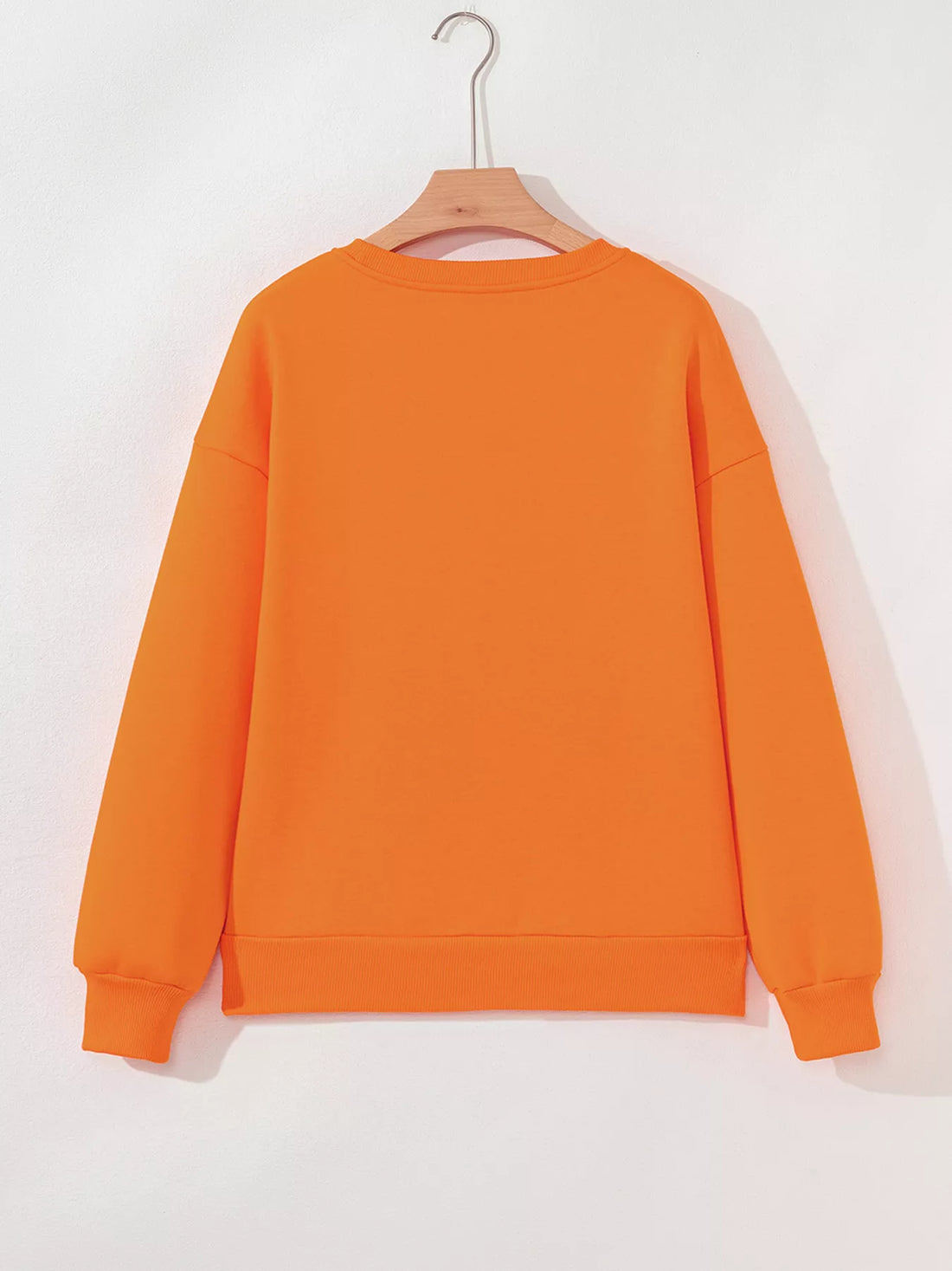 Orange Halloween crewneck sweatshirt back view on hanger, plain rear